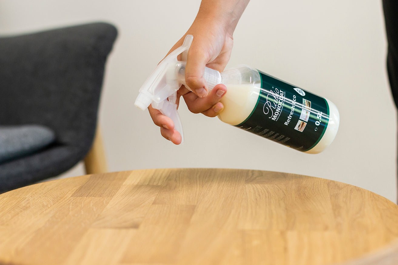 Person using Refresh Eco Spray on a wooden table